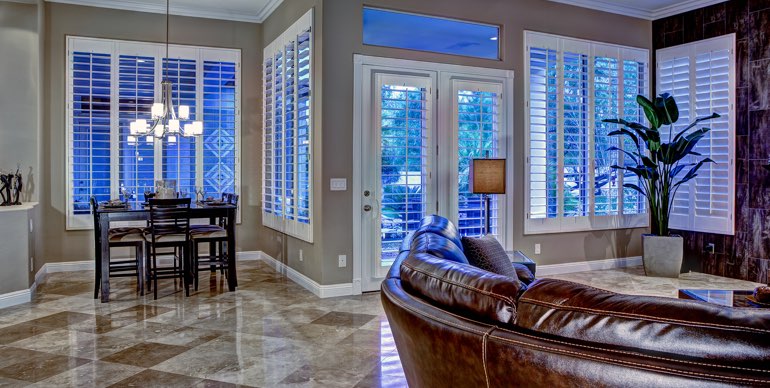 Sacramento great room with white shutters and leather furniture.